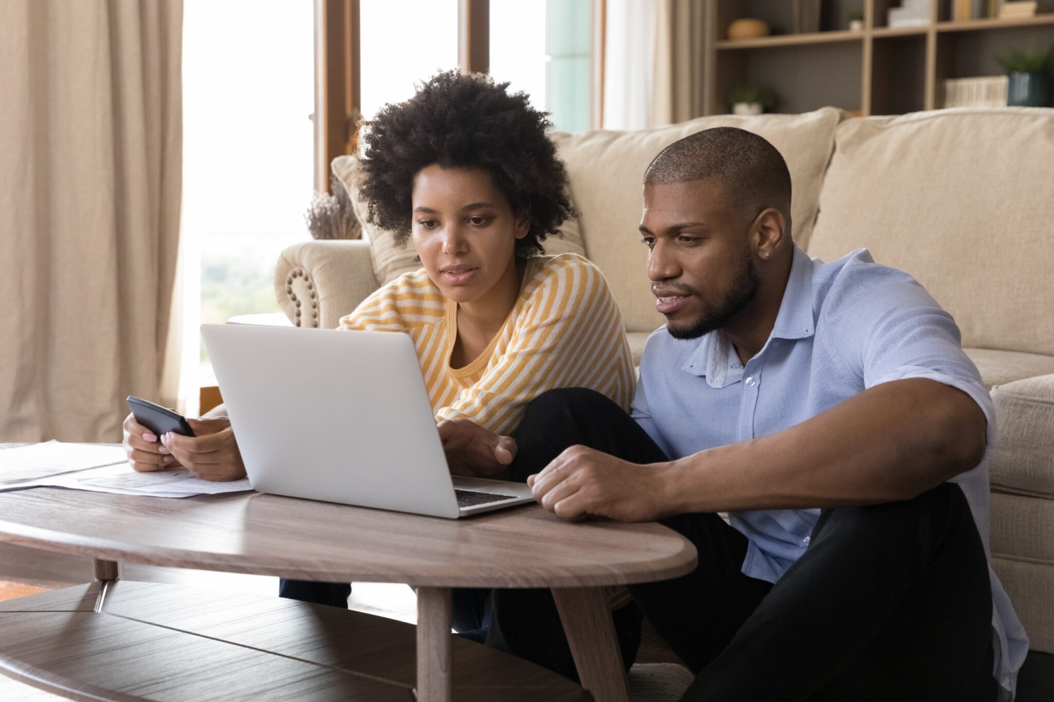 une femme et un homme devant un pc portable