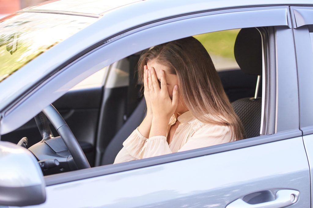 une femme au volant en train de pleurer